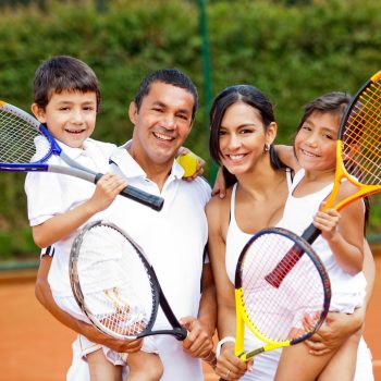 Happy,Family,Playing,Tennis,Holding,Rackets,At,The,Court